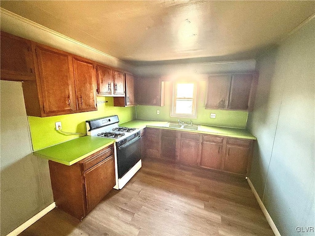 kitchen featuring light hardwood / wood-style floors and white range with gas stovetop