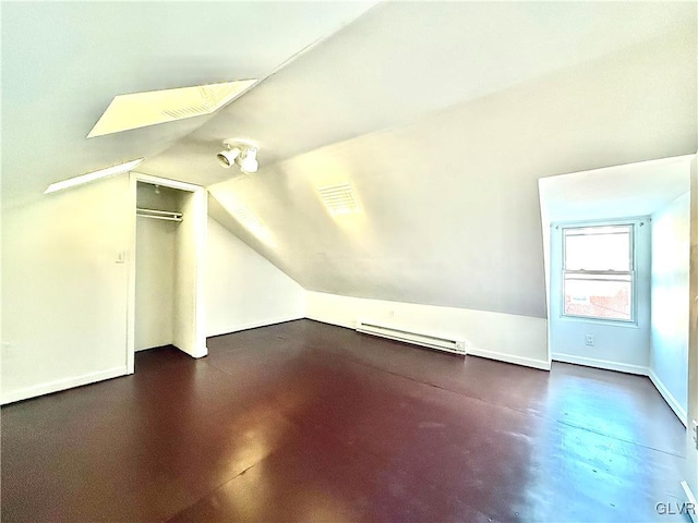 bonus room featuring a baseboard radiator and vaulted ceiling