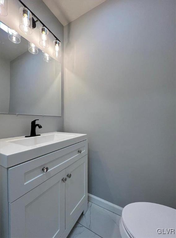 bathroom featuring toilet and vanity