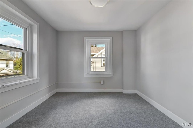 carpeted empty room featuring a wealth of natural light