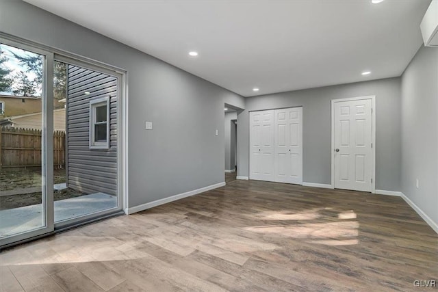 spare room featuring wood-type flooring