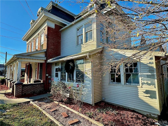 view of side of home with covered porch