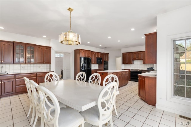 tiled dining area with a notable chandelier