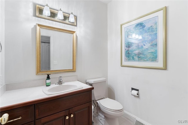 bathroom with tile patterned flooring, vanity, and toilet