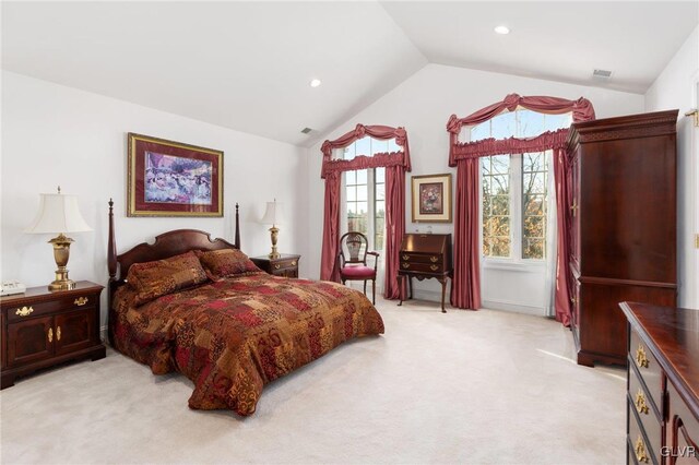 carpeted bedroom with lofted ceiling