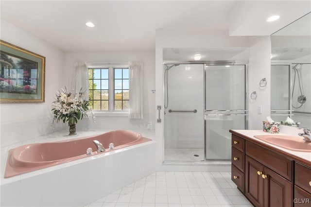 bathroom with tile patterned flooring, vanity, and plus walk in shower