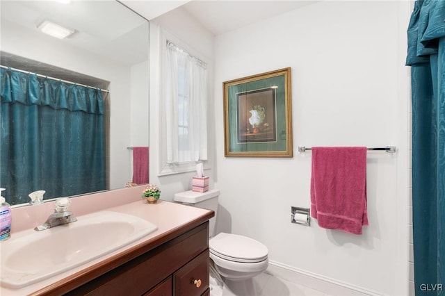 bathroom with toilet, vanity, tile patterned flooring, and walk in shower