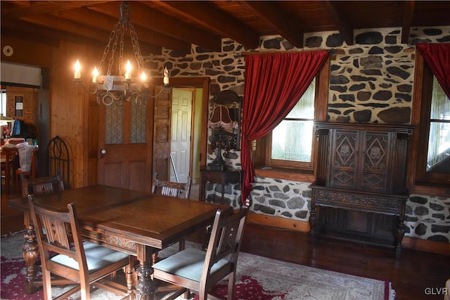 dining room with a chandelier, hardwood / wood-style flooring, wooden ceiling, and beam ceiling