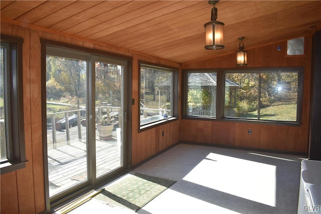 unfurnished sunroom with plenty of natural light, vaulted ceiling, and wooden ceiling