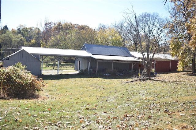 exterior space featuring a yard and a carport