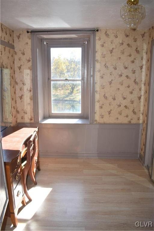 interior space featuring light hardwood / wood-style flooring and a notable chandelier