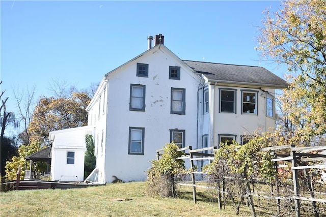 rear view of house with a lawn