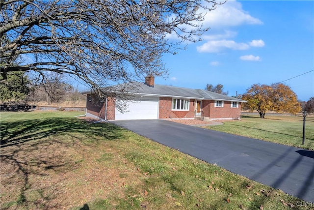 ranch-style house featuring a garage and a front lawn