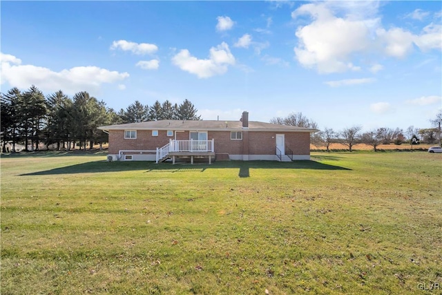 rear view of property featuring a lawn