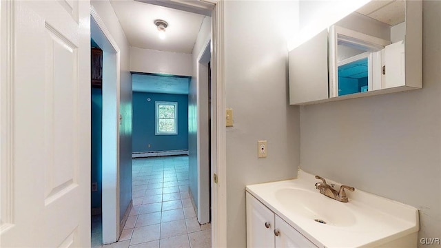 bathroom with a baseboard radiator, vanity, and tile patterned floors