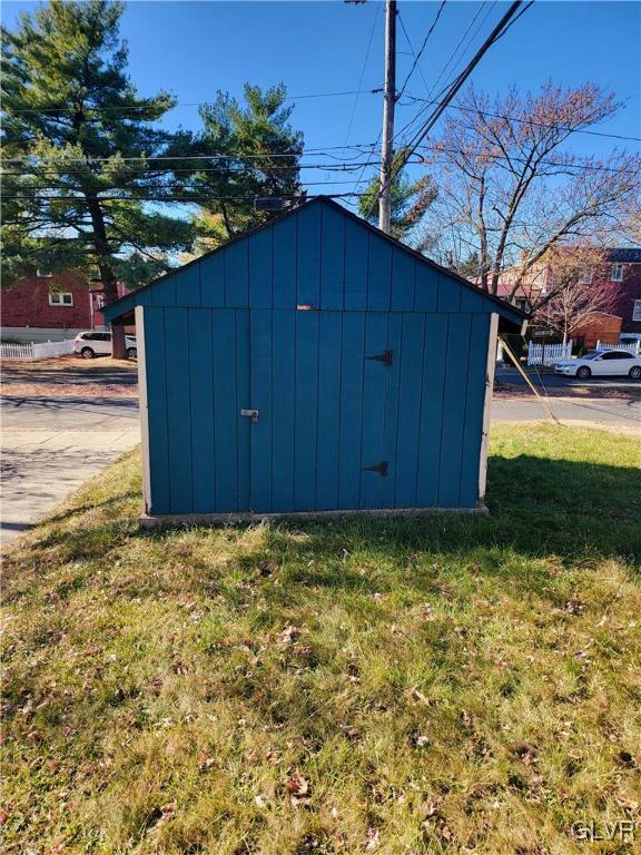 view of outbuilding featuring a yard