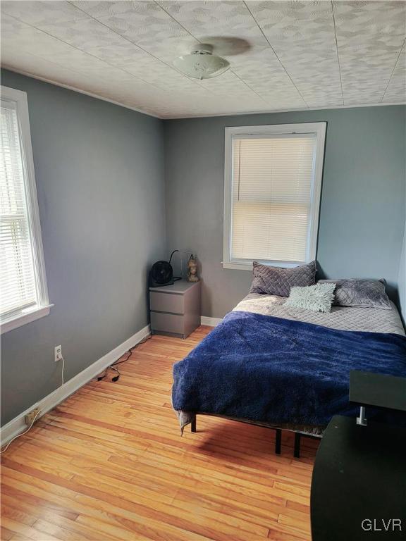 bedroom with light wood-type flooring