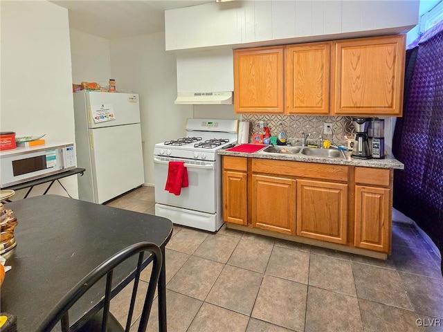 kitchen featuring backsplash, white appliances, sink, and tile patterned floors