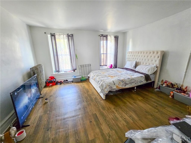 bedroom featuring radiator and dark hardwood / wood-style floors