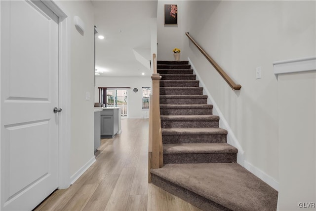 stairs with hardwood / wood-style flooring