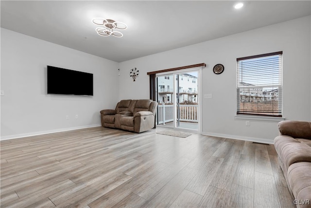 living room with light hardwood / wood-style floors and a wealth of natural light