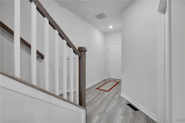 stairs featuring hardwood / wood-style floors