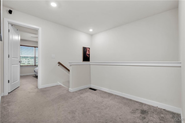 hall featuring light colored carpet