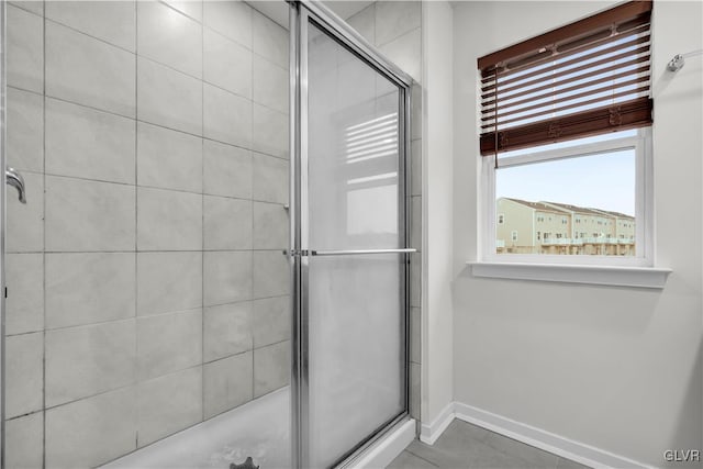 bathroom featuring tile patterned floors and a shower with door