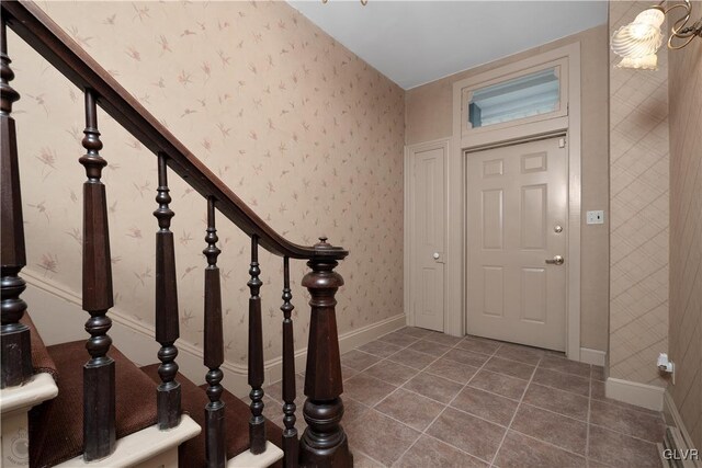 foyer with dark tile patterned flooring