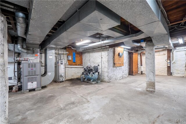 basement featuring gas water heater and heating unit