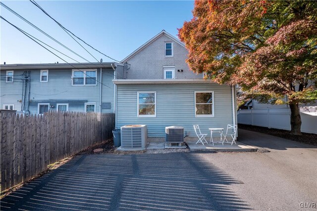 back of house with cooling unit and a patio area