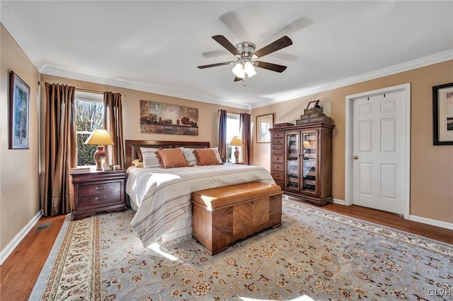 bedroom featuring crown molding, light hardwood / wood-style flooring, multiple windows, and ceiling fan