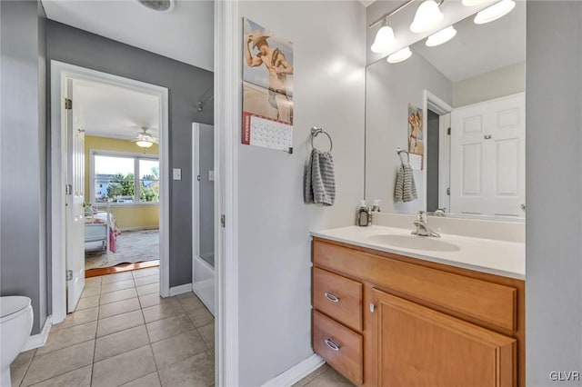 bathroom with vanity, ceiling fan, tile patterned flooring, and toilet