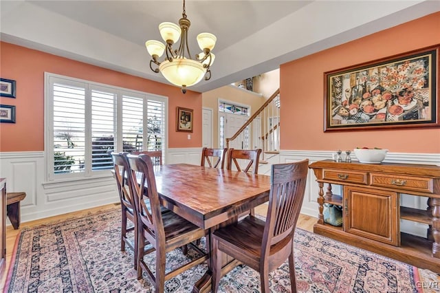 dining space featuring light hardwood / wood-style flooring and a notable chandelier