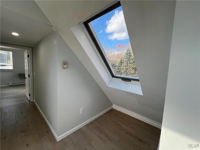 bonus room featuring hardwood / wood-style floors, baseboard heating, and a skylight