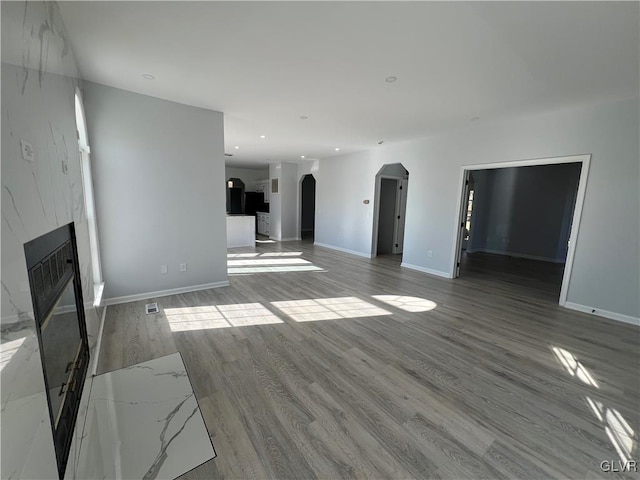 unfurnished living room with light hardwood / wood-style flooring