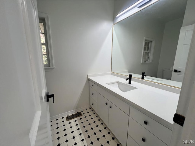 bathroom featuring vanity and toilet