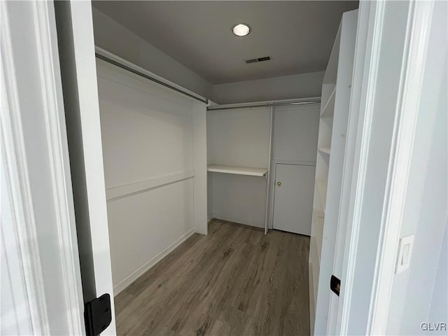 walk in closet featuring light hardwood / wood-style flooring