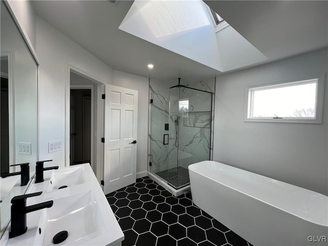 bathroom with vanity, a skylight, tile patterned floors, and separate shower and tub