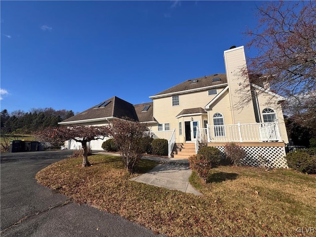 view of front of property with a front lawn and a deck