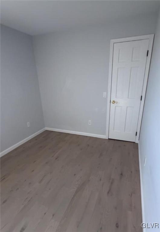 spare room with wood-type flooring