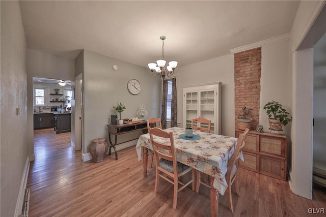 dining room with hardwood / wood-style flooring and ceiling fan with notable chandelier