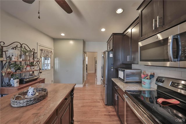 kitchen featuring appliances with stainless steel finishes, ceiling fan, backsplash, dark brown cabinets, and light hardwood / wood-style flooring