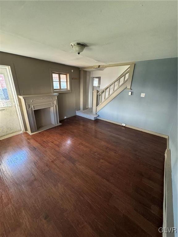 unfurnished living room featuring dark hardwood / wood-style flooring