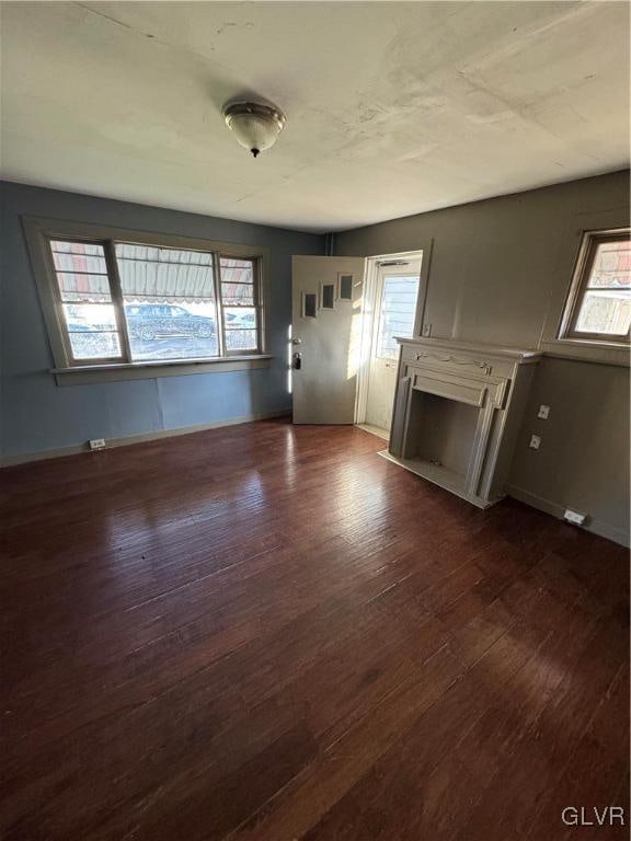 unfurnished living room with dark wood-type flooring