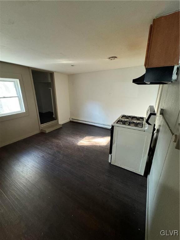 interior space with white range with gas cooktop, a baseboard heating unit, and dark wood-type flooring