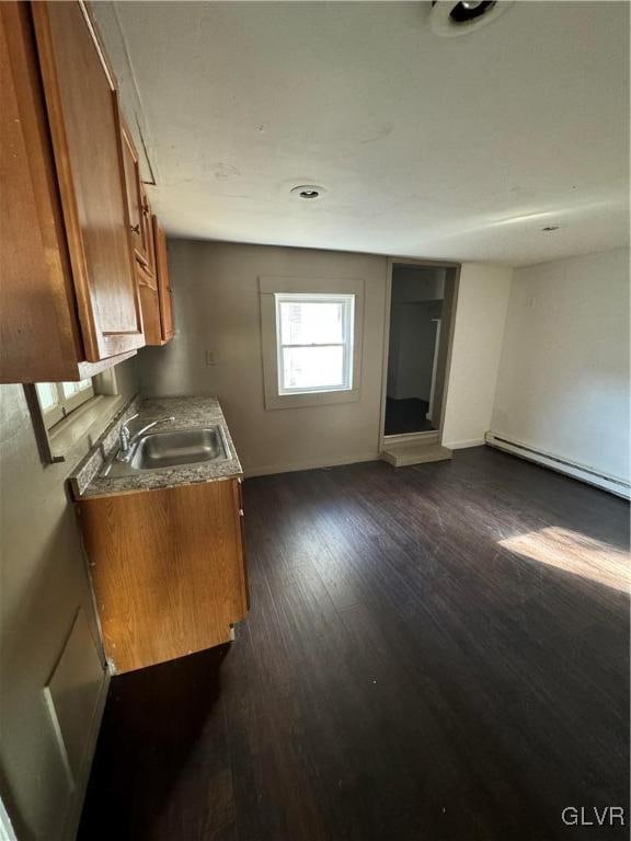 kitchen featuring a baseboard radiator, sink, and dark hardwood / wood-style flooring