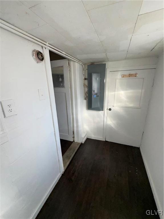 hallway with electric panel and dark hardwood / wood-style floors