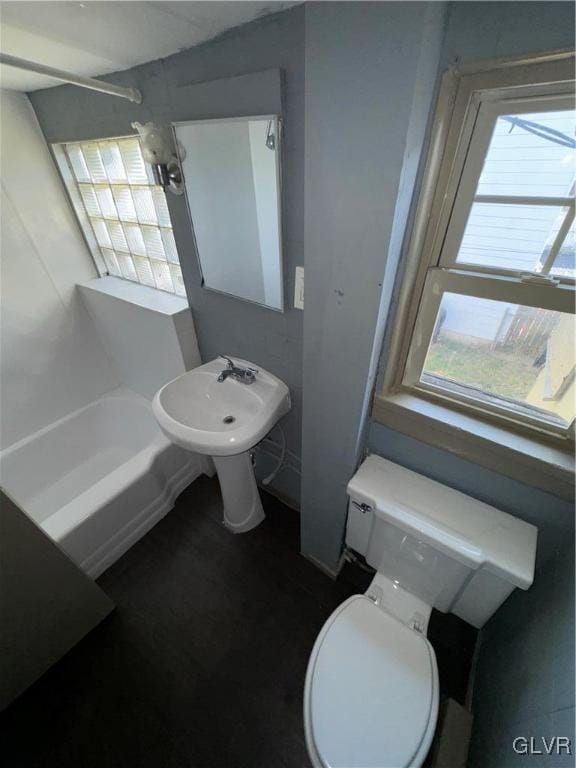 bathroom featuring a healthy amount of sunlight and toilet