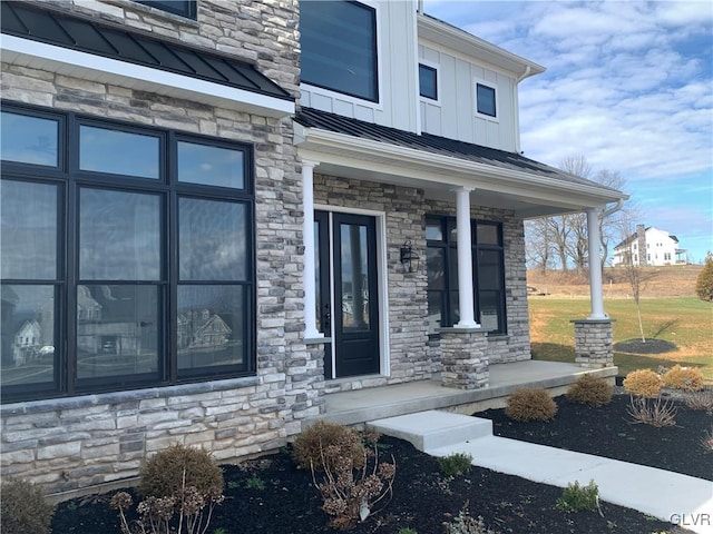 view of exterior entry featuring covered porch